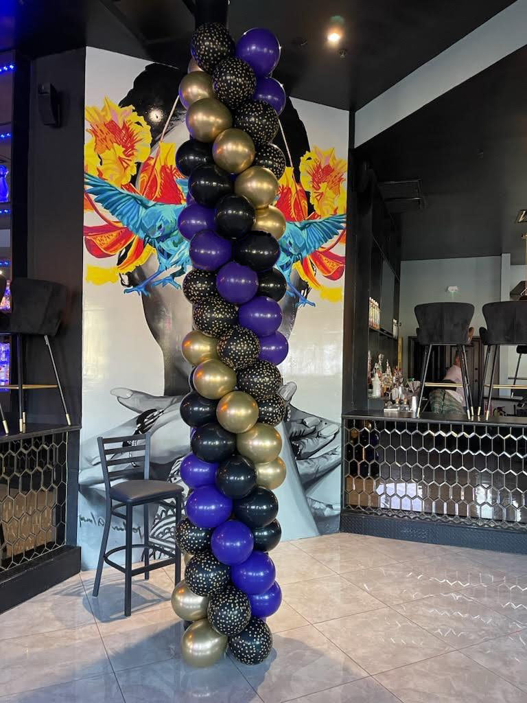 Gold black and purple balloon column